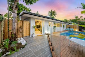 a pool house with a deck and a swimming pool at City Haven - A Slice of Paradise Fringing the CBD in Cairns