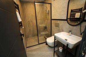 a bathroom with a shower and a toilet and a sink at Arkem Hotel 2 in Istanbul