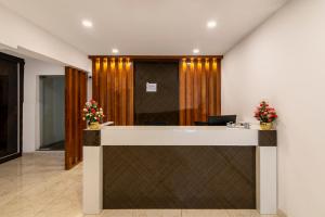 un vestíbulo de oficina con una recepción con flores en Gateway Premium Inn en Bangalore