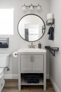 a bathroom with a white sink and a mirror at Sauceda Cottage at Wrenwood Ranch, King Bed in Johnson City