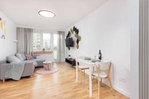 a living room with a couch and a table at Apartament Pomorska in Gdańsk