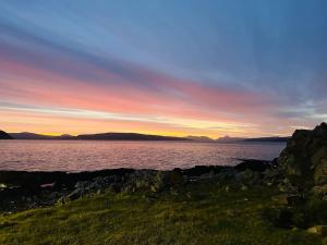 a sunset over a large body of water at Argyll House Ben More in Salen