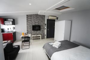 a bedroom with a bed and a kitchen with a table at Arkem Hotel 3 in Istanbul