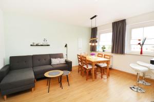 a living room with a couch and a table at Ferienwohnung zum Möwennest in Peenemünde