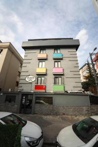 a building with colorful windows and cars parked in front of it at Arkem Hotel 3 in Istanbul