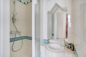 a bathroom with a sink and a shower with a mirror at Splendid spacious apartment Paris 16 in Paris