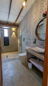 a bathroom with a sink and a toilet and a mirror at Misty Villa Powered by TSC in Pussellawa