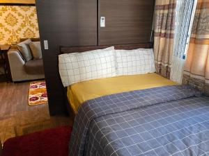 a bedroom with a bed and a couch in a room at Luxury Urban Bliss-Stylish 3 Bedroom 4room Makati Oasis in Air residence in Manila +38 photos