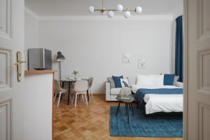 a living room with a bed and a dining room at AIRSTAY PRAGUE apartment Vinohrady in Prague