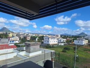 a view of the city from the balcony of a house at Enjoy Paradise Newave Holiday - Appartment No 8 in Flic-en-Flac