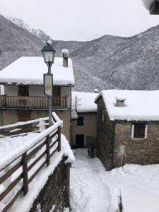 a street light covered in snow next to a building at A REALDO - Casa Paolina in Triora +5 photos