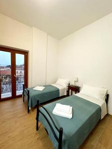 two beds in a room with a window at La Casa di Garibaldi in San Demetrio neʼ Vestini