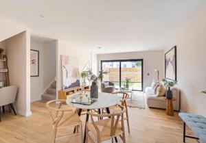 a living room with a table and chairs at Kings Mews Elegance: City Sparrow's Premier 2-Bedroom Residences in London