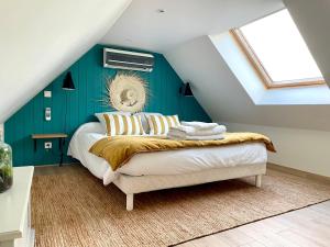 sypialnia z łóżkiem z niebieską ścianą w obiekcie Gîte de la Croix w mieście Villechétif