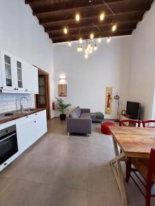 a kitchen and living room with a couch and a table at Apartamentos La Florida in Arrecife