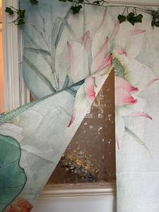 a painting of pink flowers on a wall at Single room in shared flat Valley Hill, Loughton in Loughton +16 photos
