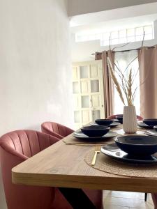 a wooden table with black bowls and plates on it at AK Suites in Imerovigli