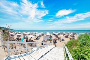a beach with a bunch of people on the sand at Premier Fort Beach Hotel in Sveti Vlas