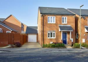a brick house with a driveway in front of it at New and Comfortable with Parking in Andover