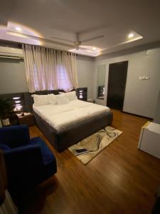 een slaapkamer met een groot bed en een bank bij KAFT2 HOTELS in Ijebu Ode