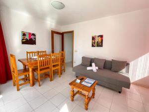 a living room with a couch and a table at Apartamentos Playa Oropesa 3000 in Oropesa del Mar