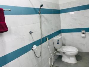 a shower in a bathroom with a toilet at Tashil Hotel & Restaurant in Tissamaharama