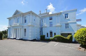 a large white house with a driveway at Allerdale in Torquay