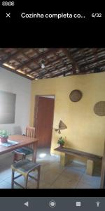 a room with a table and a table and a chair at Chácara lua e sol in Pouso Alegre