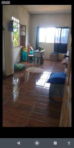 a living room with a wooden floor and a table at Chácara lua e sol in Pouso Alegre