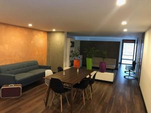 a living room with a table and a couch at Best view Bogota Central Hostel in Bogotá