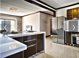 a large kitchen with stainless steel appliances in a room at Cedar Fourways Sandton in Trevallyn