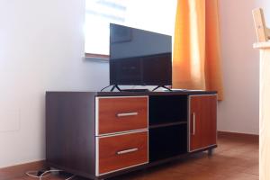a entertainment center with a flat screen tv on it at Moon Valley la pelosa in Stintino