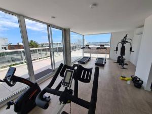 a gym with two treadmills and a large window at Encantador Apartamento en la mejor ubicación in Punta del Este