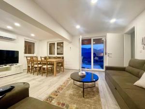 a living room with a couch and a table at Sky view villa in Obrovac