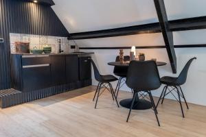 a kitchen with a table and chairs in a room at Dream apartments in Hoogwoud +19 photos