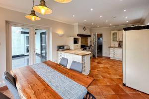 a bedroom with a wooden bed in a kitchen at Stunning house, sleeps 10, garden and pool table - West Parley Manor in West Parley