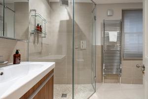 a bathroom with a glass shower and a sink at Stay Trafalgar Square in London