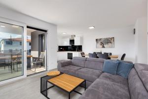 a living room with a couch and a table at Apartma Skubic Murvica in Vantačići
