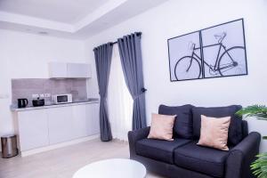 a living room with a couch and a bike on the wall at House4 in Lekki
