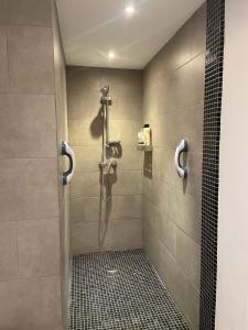a shower stall in a bathroom with a tile floor at Lovely Apartment Orba Alicante in Orba