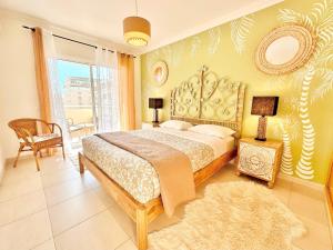 a bedroom with a large bed and a window at Elegant seaview apartment Praia da Rocha in Portimão
