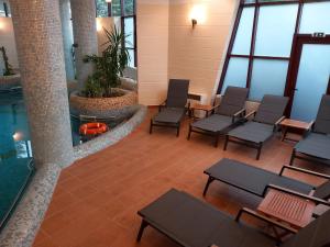 an empty waiting room with chairs and a pool at Denisa Boutique in Poiana Brasov