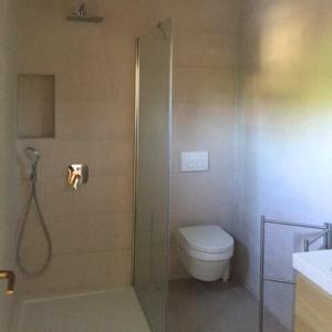 a bathroom with a shower with a toilet and a sink at Apartments Vila Miranda 2 in Barbat na Rabu