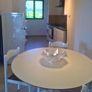 a kitchen with a table with chairs and a refrigerator at Apartments Vila Miranda 2 in Barbat na Rabu +44 photos