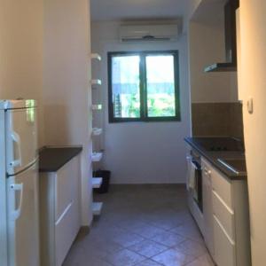 Il comprend une cuisine équipée d'un réfrigérateur et d'une fenêtre. dans l'établissement Apartments Vila Miranda 2, à Barbat na Rabu