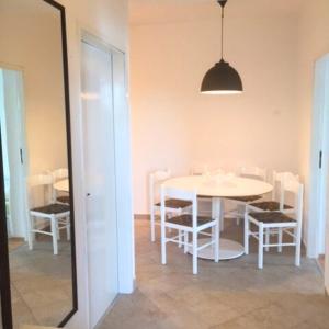 a dining room with a white table and chairs at Apartments Vila Miranda 2 in Barbat na Rabu