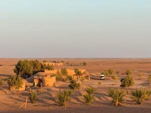 a village in the middle of a desert at M'hamid Desert Camp Tours in Mhamid