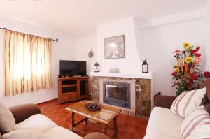 a living room with a fireplace and a tv at Villa el Barco Spainsunrentals 1200 in Nerja