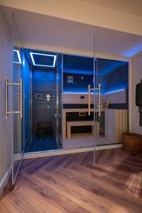 a room with a piano inside of a glass door at Hotel Brown Beach House & Spa in Trogir
