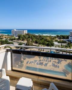 a balcony with a view of a beach and the ocean at Sanders Florida in Ayia Napa